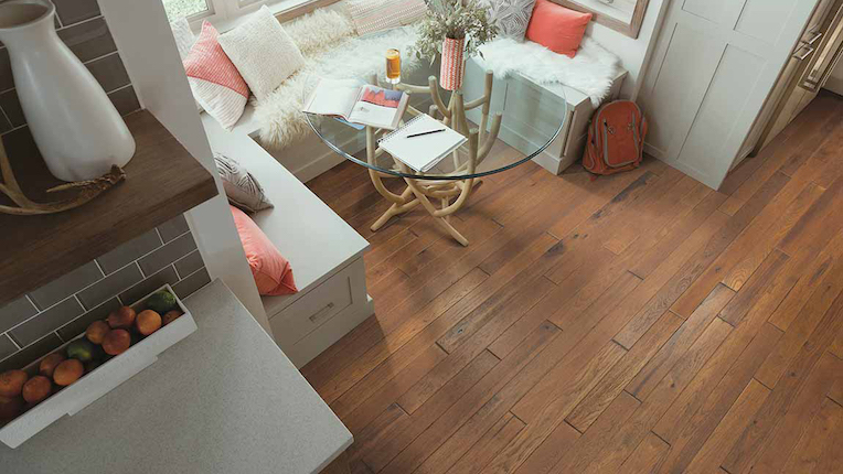 rich hardwood floors in a dining area with a cozy breakfast nook